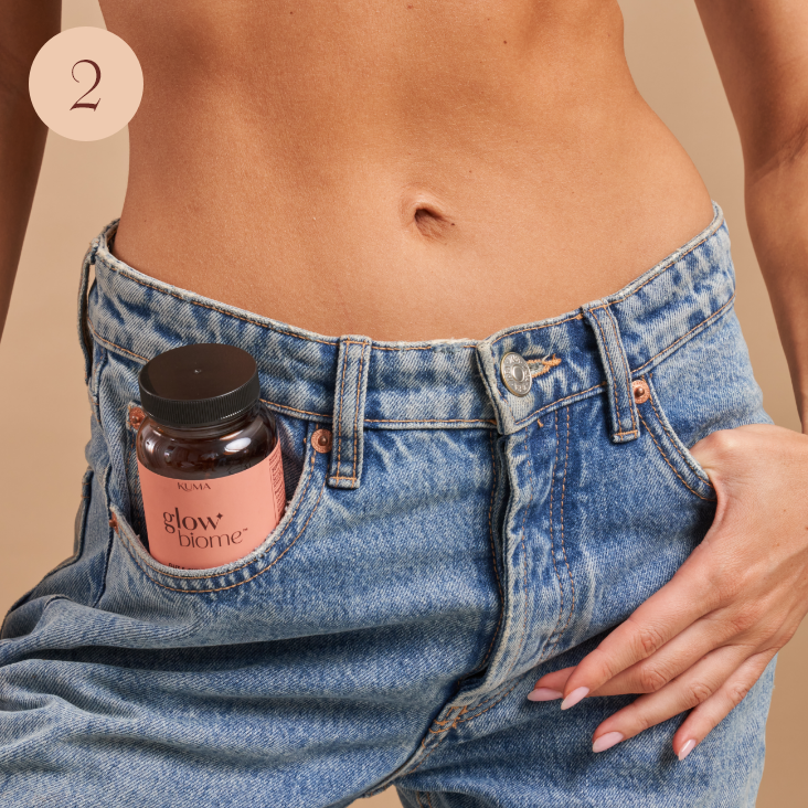 image of women holding Glow Biome bottle in her jeans pocket